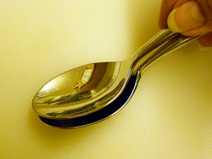 crushing an aspirin between two spoons